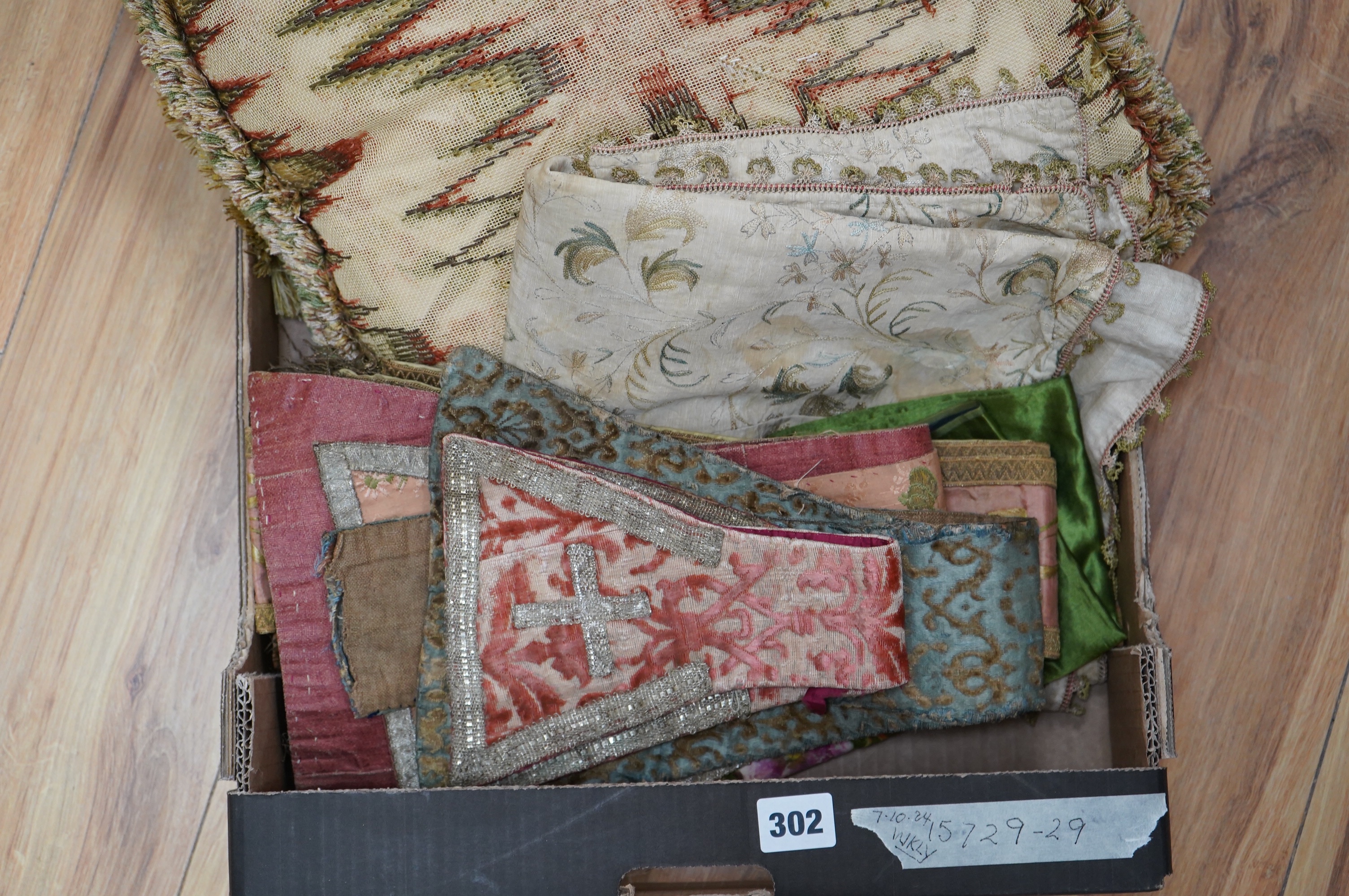 A collection of 18th and 19th century textiles, to include religious Maniples, two cushions, an embroidered chain stitch table cover with intricate edging, a Chinese embroidered panel and floral painted satin. Condition